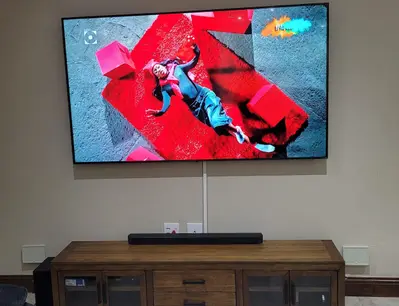 Wall-mounted TV and soundbar in a family living room